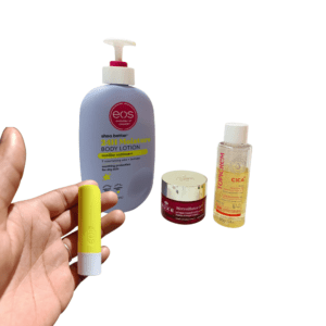 winter beauty essentials for hydrated skin with body lotion, face cream, lip balm, and stretchmark oil